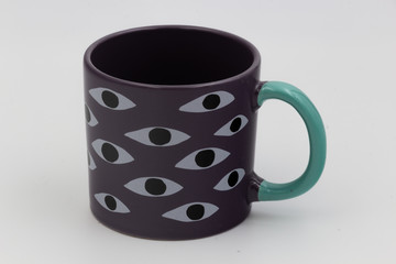 Cup with printed eyes are on white background, enough space for the text.
