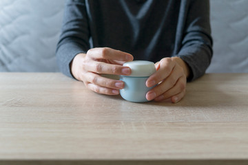 Woman doing the manicure. Removing the polish and putting on the cream. Woman that care his hands. Style concept.