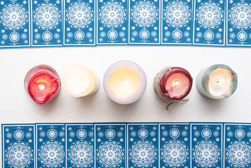 Tarot cards over white table background.