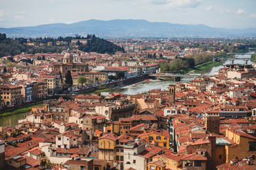 Naklejka na ściany i meble Beautiful super wide-angle aerial view of Florence, Italy with Florence Cathedral di Santa Maria del Fiore, mountains, skyline and scenery beyond the city, seen from the tower of Palazzo Vecchio