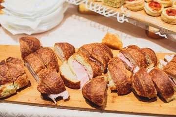 Beautifully decorated catering banquet table with different food snacks and appetizers on christmas birthday party event or wedding celebration, concept of Italian antipasti wine snacks variety set