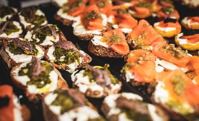 Beautifully decorated catering banquet table with different food snacks and appetizers on christmas birthday party event or wedding celebration, concept of Italian antipasti wine snacks variety set