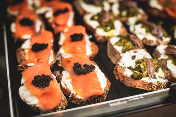 Beautifully decorated catering banquet table with different food snacks and appetizers on christmas birthday party event or wedding celebration, concept of Italian antipasti wine snacks variety set