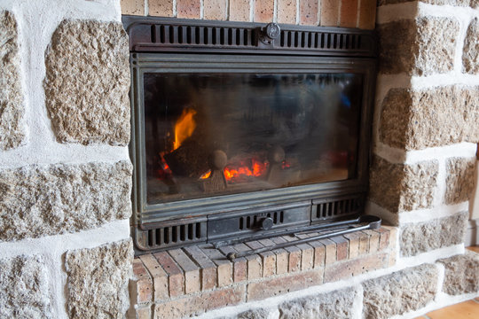 Fireplace Insert With A Fire In A Living Room