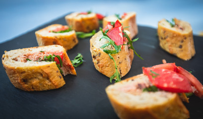 Beautifully decorated catering banquet table with different food snacks and appetizers on christmas birthday party event or wedding celebration, concept of Italian antipasti wine snacks variety set