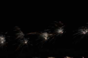 colorful fireworks of different colors lights and glitter on the night sky in summer