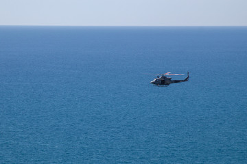 Helicopter aunt over the clear blue sea and beautiful cloudless sky
