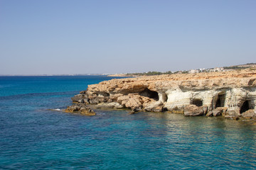 Beautiful white rocky shore with blue sea water