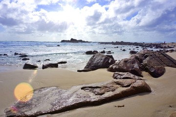 Rocky Sandy Beach on Cloudy Stormy Day with Ocean Waves