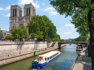 The view of Notre Dame in Paris with the canl and boat