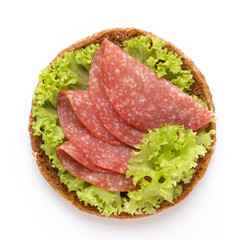 Sandwich with salami sausage on white background.