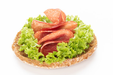 Sandwich with salami sausage on white background.