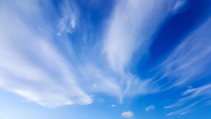 High white wispy cirrus clouds with cirri-stratus in the blue sky