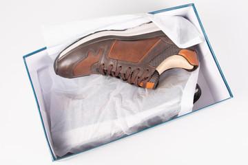 brown sneakers pair men on white paper box