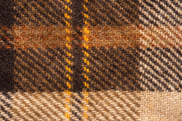 Brown checked fabric. Scottish wool. Fabric for coat plaid suit. Close-up. Background