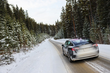 Electric car driving, mountains snow