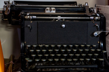 Grodno, Belarus, January 16, 2019: Old typewriter continental. German quality. Located on the shelf next to the books. Keys close up. Antiques, historical value.