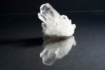 Quartz also called deep quartz with mineral inclusions in the studio in front of black background...