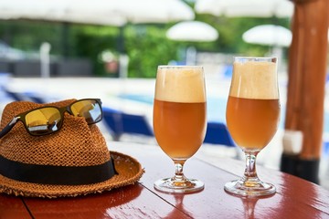 Cold beer on table outdoor in summer