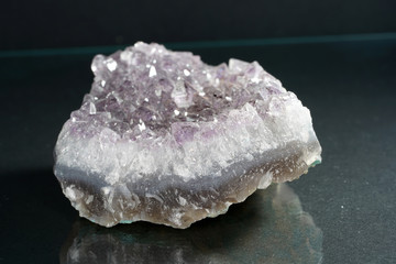 Quartz also called deep quartz with mineral inclusions in the studio in front of black background...