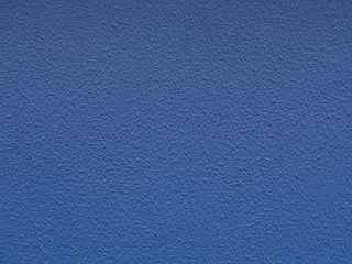 Blue backdrop with ornament.. Paper texture. Dark blue stucco surface. Concrete wall. Abstract pattern, embossed background. Texture of paint on grooved plaster.