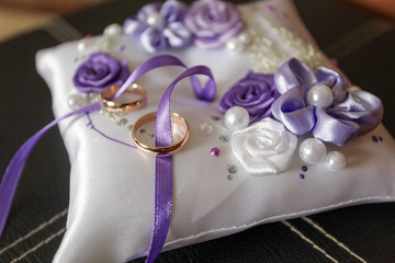 Wedding rings on a pillow close-up