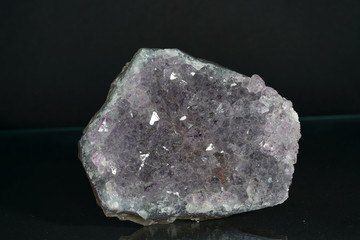 Quartz also called deep quartz with mineral inclusions in the studio in front of black background...