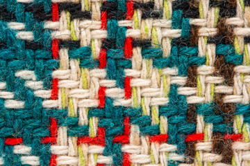 Brown checkered fabric with colored threads. Scottish wool. Fabric for plaid coat and suit. Close-up. Background