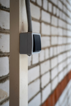Outdoor light electic switch on iron stand and birck wall