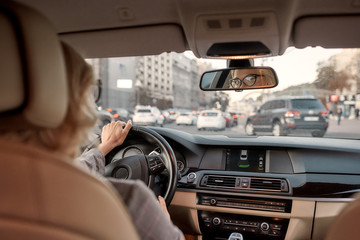 I'm in love with my car. Reflection of woman in the rear-view mirror of the car. Business woman...