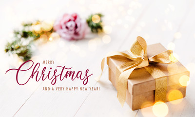 Romantic, golden christmas gift box with bright, light background and feminine, pastel colors / banner, header and elegant greeting text