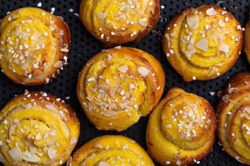 Swedish traditional christmas bun Lussekatter or Lussebullar on a rustic wooden table background