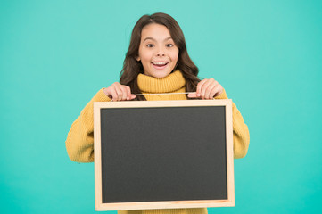 Happy small child make hand gesture presenting product. big sales advertising. best prices. useful info here. welcome on board. happy small girl hold blackboard. copy space for your announcement