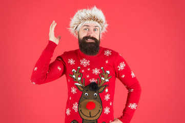 very little time left. winter holiday activity. warm clothes in cold weather. happy new 2020 year. bearded man on red background. funny man with beard in knitted sweater. funny hipster in earflap hat