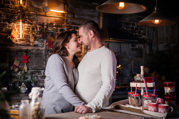 Portrait of a young couple in the living room at Christmas.