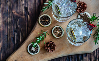 Ideas of winter drinks from gin and tonic for the new year. A bottle of gin and water tonic on a...