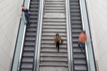 People rushing in escalators