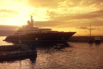 Beautiful sunset with golden colours and clouds in famous round port and marina of Zea or Passalimani, Piraeus, Attica, Greece