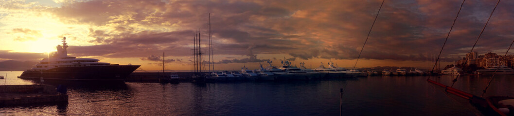 Fototapeta premium Beautiful sunset with golden colours and clouds in famous round port and marina of Zea or Passalimani, Piraeus, Attica, Greece