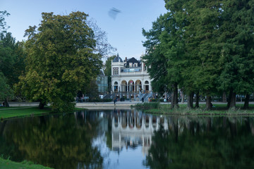 Fototapeta na wymiar Building and trees reflected in water