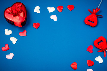 Red heart with a gift to Valentine's Day on a beautiful blue background. Heart pendant. Space for...