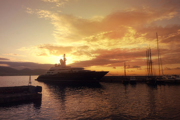 Obraz premium Beautiful sunset with golden colours and clouds in famous round port and marina of Zea or Passalimani, Piraeus, Attica, Greece