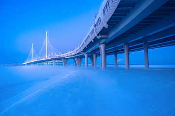 Saint Petersburg. Russia. Bridge to Krestovsky island. Gulf of Finland. Expressway in St. Petersburg. Winter fog. Car trip in Russia. Road architecture of Petersburg. Bridges of the Russia