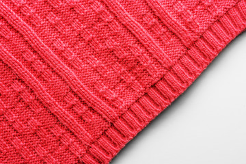 The texture of a knitted sweater. Red pattern. Facial surface. Background. Copy space