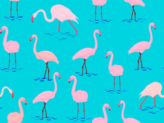 Seamless pattern with pink flamingo birds on a blue background.