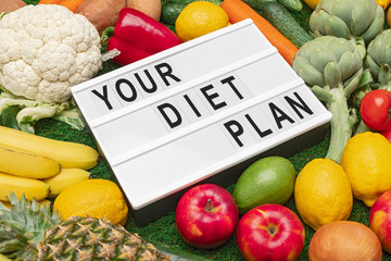 Assorted diet food near board with inscription