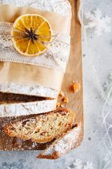 Holiday baking. Christmas cake. Stollen is fruit bread of nuts, spices, dried or candied fruit, coated with powdered sugar. It is traditional German bread eaten in the Christmas season. New year