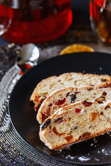 Holiday baking. Christmas cake. Stollen is fruit bread of nuts, spices, dried or candied fruit, coated with powdered sugar. It is traditional German bread eaten in the Christmas season. New year