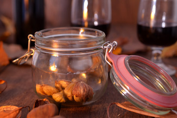 glass jar with roasted chestnuts in an autumn rustic background