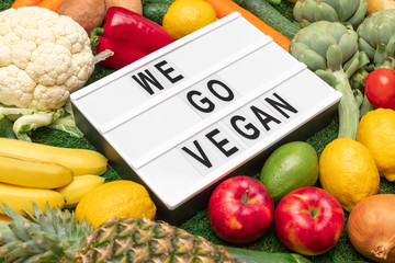 Vegetarian food around board with writing